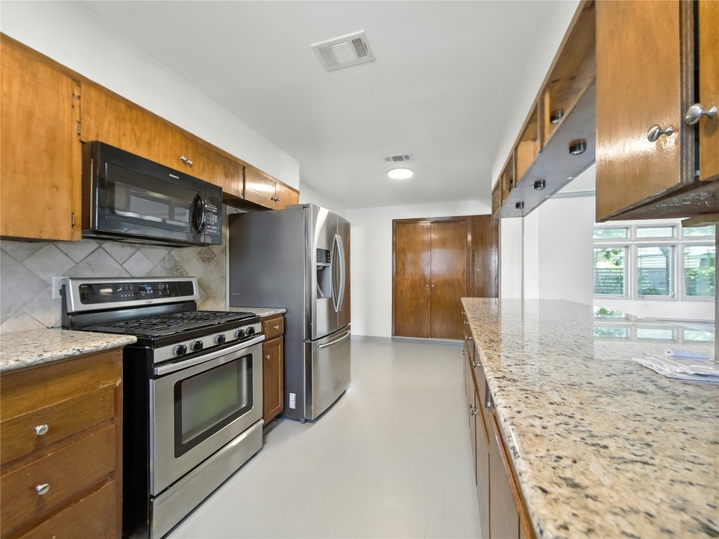 1604 Springdale Road Austin, TX 78721 - Photo 9 of 29 a kitchen with a stove and a microwave