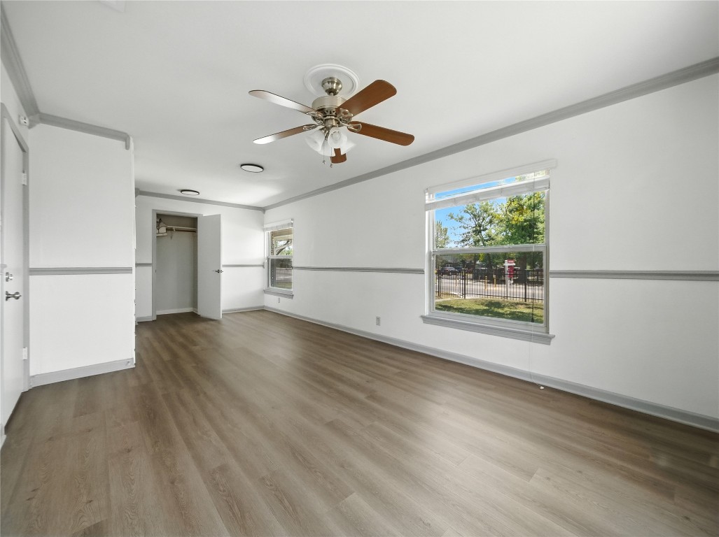 1604 Springdale Road Austin, TX 78721 - Photo 10 of 29 a view of empty room with wooden floor and fan