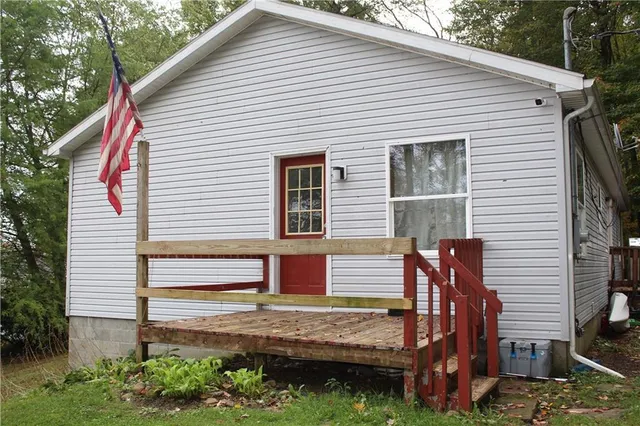a view of a house with a yard and sitting area