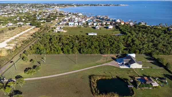 an aerial view of residential houses with outdoor space