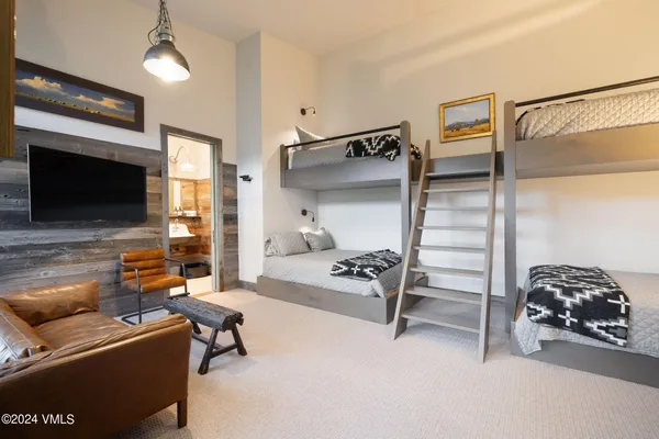 a bedroom with furniture and a flat screen tv