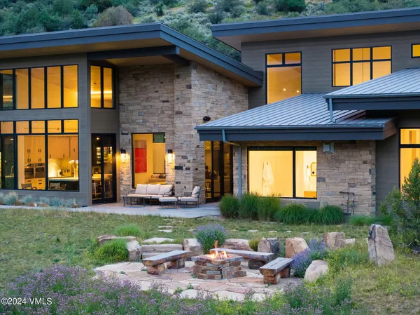 a view of a house with a swimming pool and sitting area