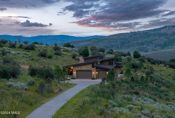 an aerial view of a house with mountain view