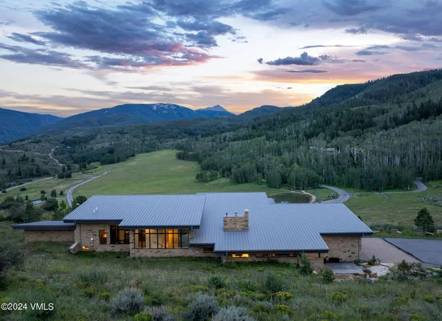 an aerial view of a house with mountain view