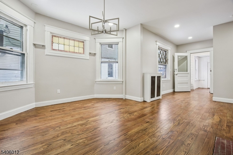 99 Lincoln Street Montclair, NJ 07042 - Photo 11 of 28 a view of an empty room with a window and wooden floor