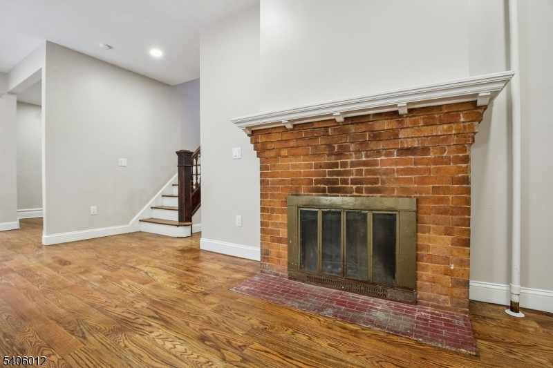 99 Lincoln Street Montclair, NJ 07042 - Photo 13 of 28 a view of an empty room with wooden floor and a fireplace