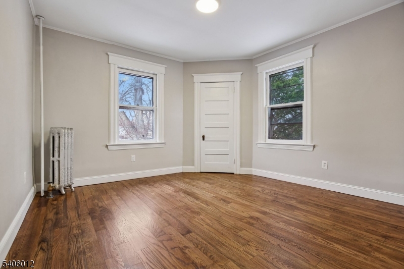 99 Lincoln Street Montclair, NJ 07042 - Photo 22 of 28 an empty room with wooden floor and windows
