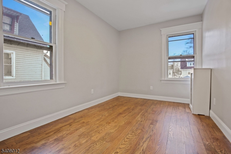 99 Lincoln Street Montclair, NJ 07042 - Photo 23 of 28 a view of an empty room with wooden floor and a window