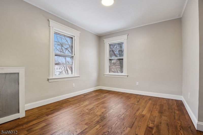 99 Lincoln Street Montclair, NJ 07042 - Photo 24 of 28 an empty room with wooden floor and windows