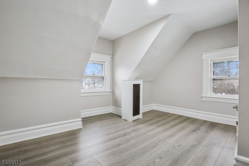 99 Lincoln Street Montclair, NJ 07042 - Photo 27 of 28 an empty room with wooden floor and windows