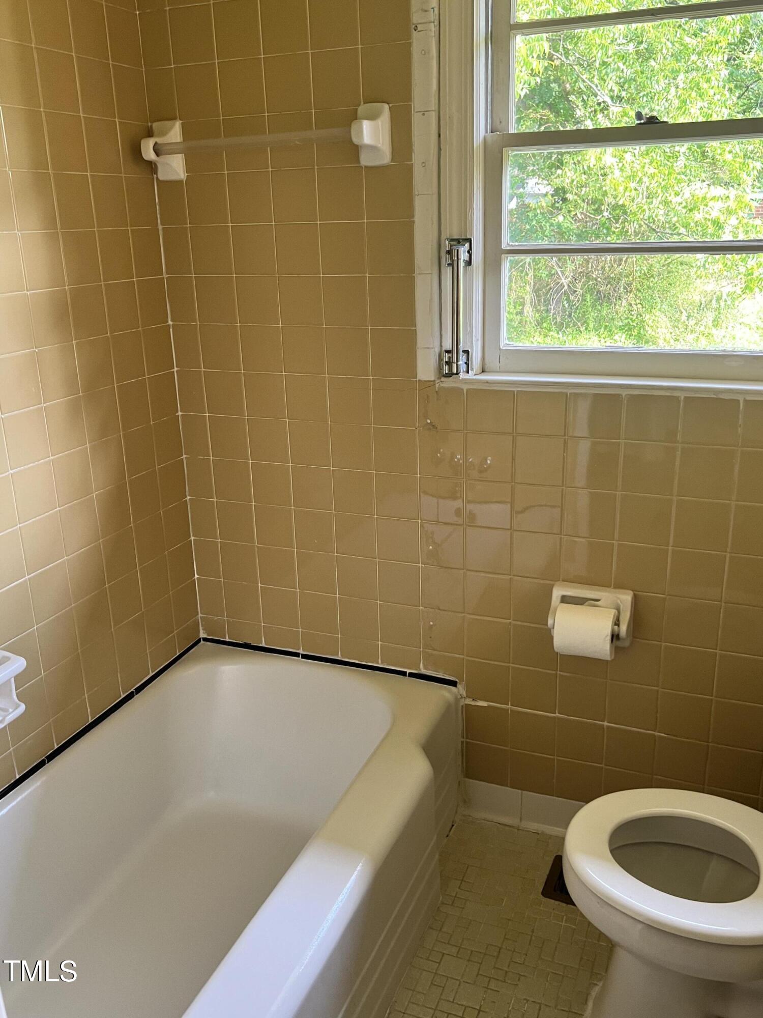 3226 Bunnlevel Erwin Road Erwin, NC 28339 - Photo 12 of 21 a bathroom with a blue toilet and a shower