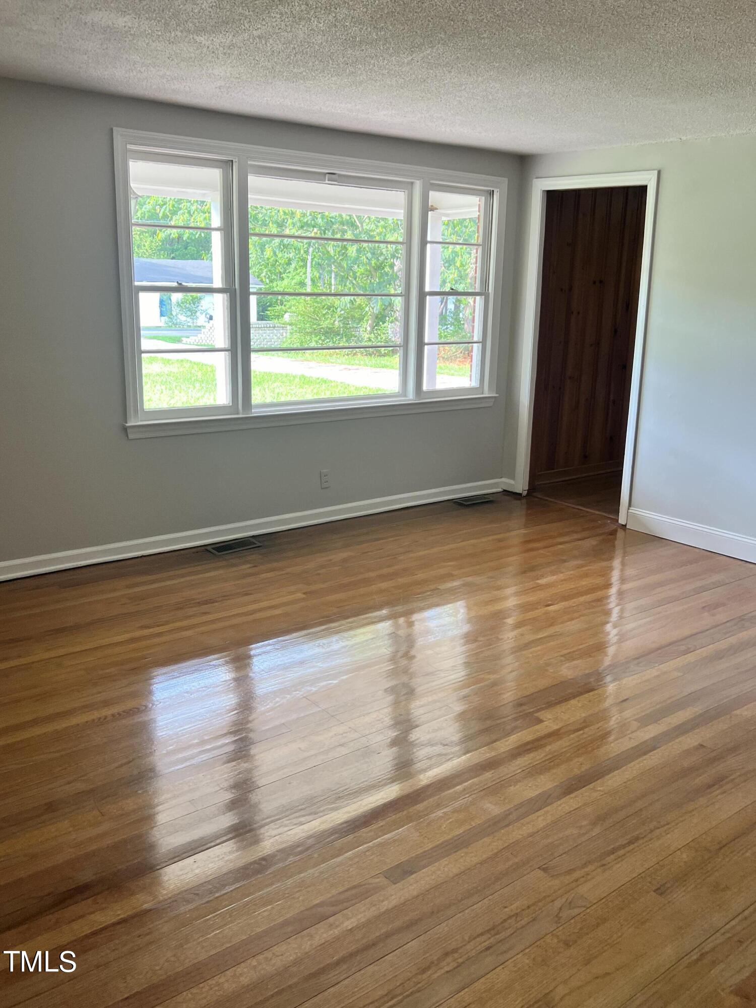 3226 Bunnlevel Erwin Road Erwin, NC 28339 - Photo 16 of 21 a view of an empty room with wooden floor and a window