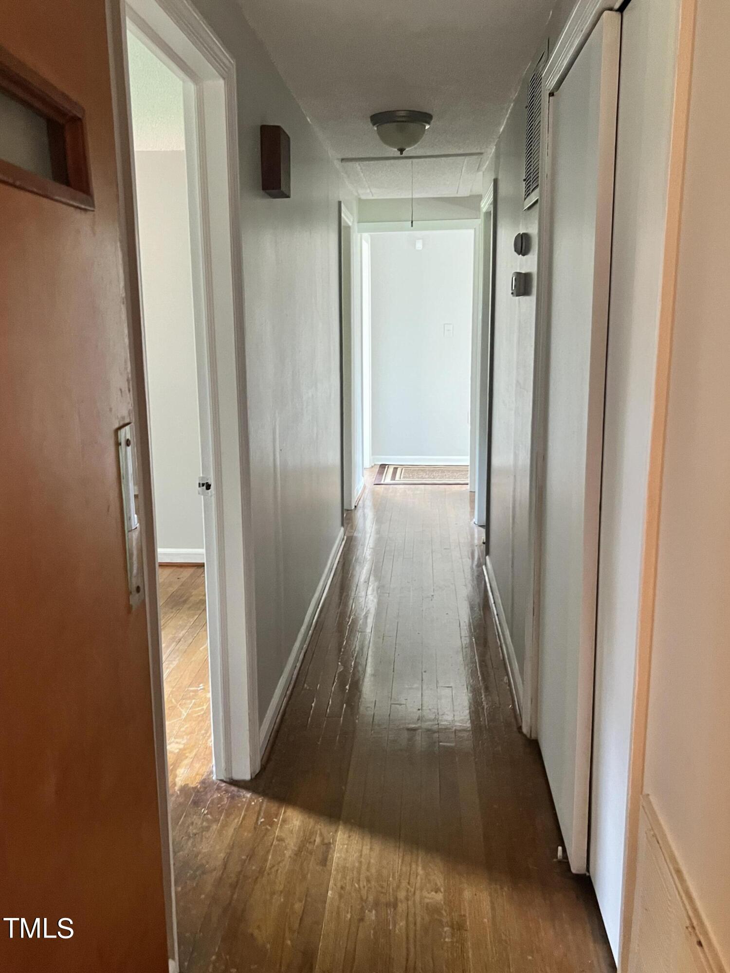 3226 Bunnlevel Erwin Road Erwin, NC 28339 - Photo 8 of 21 a view of a hallway with wooden floor and staircase