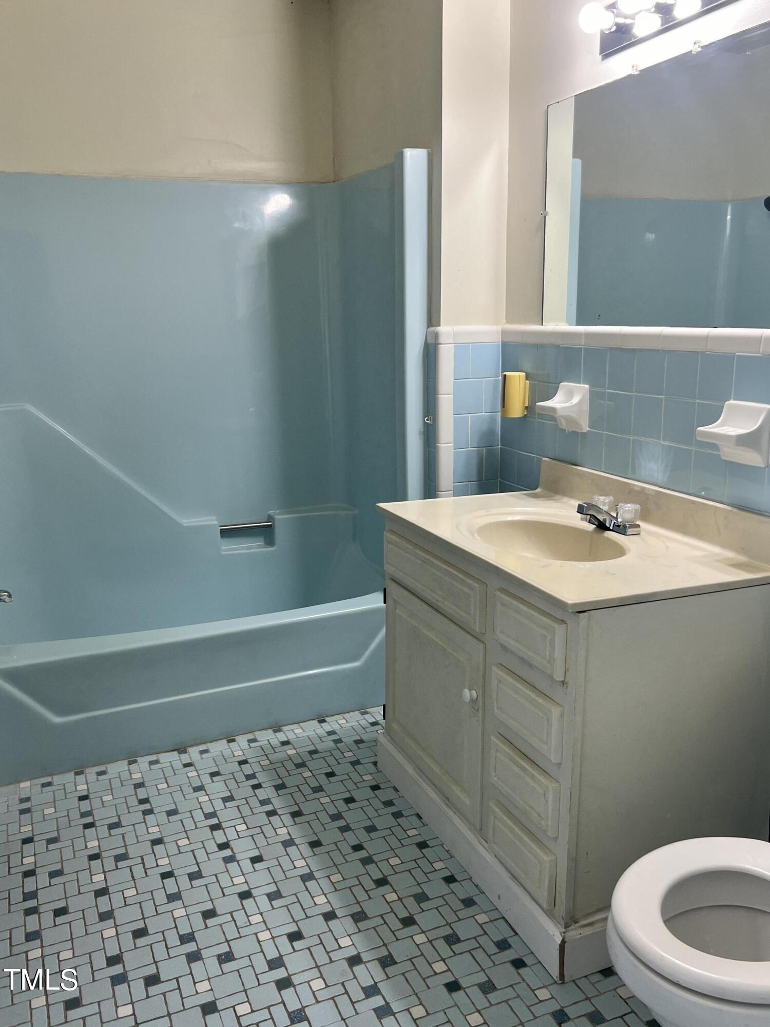 3226 Bunnlevel Erwin Road Erwin, NC 28339 - Photo 9 of 21 a bathroom with a sink a toilet and shower