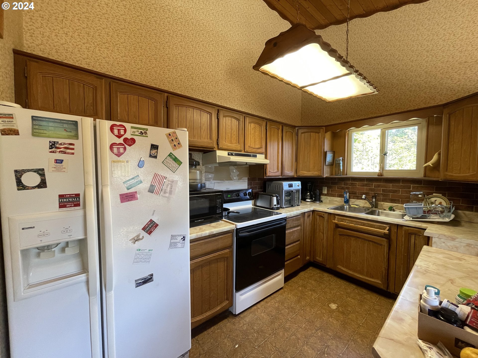96333 Wildwood Road Brookings, OR 97415 - Photo 10 of 19 a kitchen with a refrigerator a stove a sink and a refrigerator