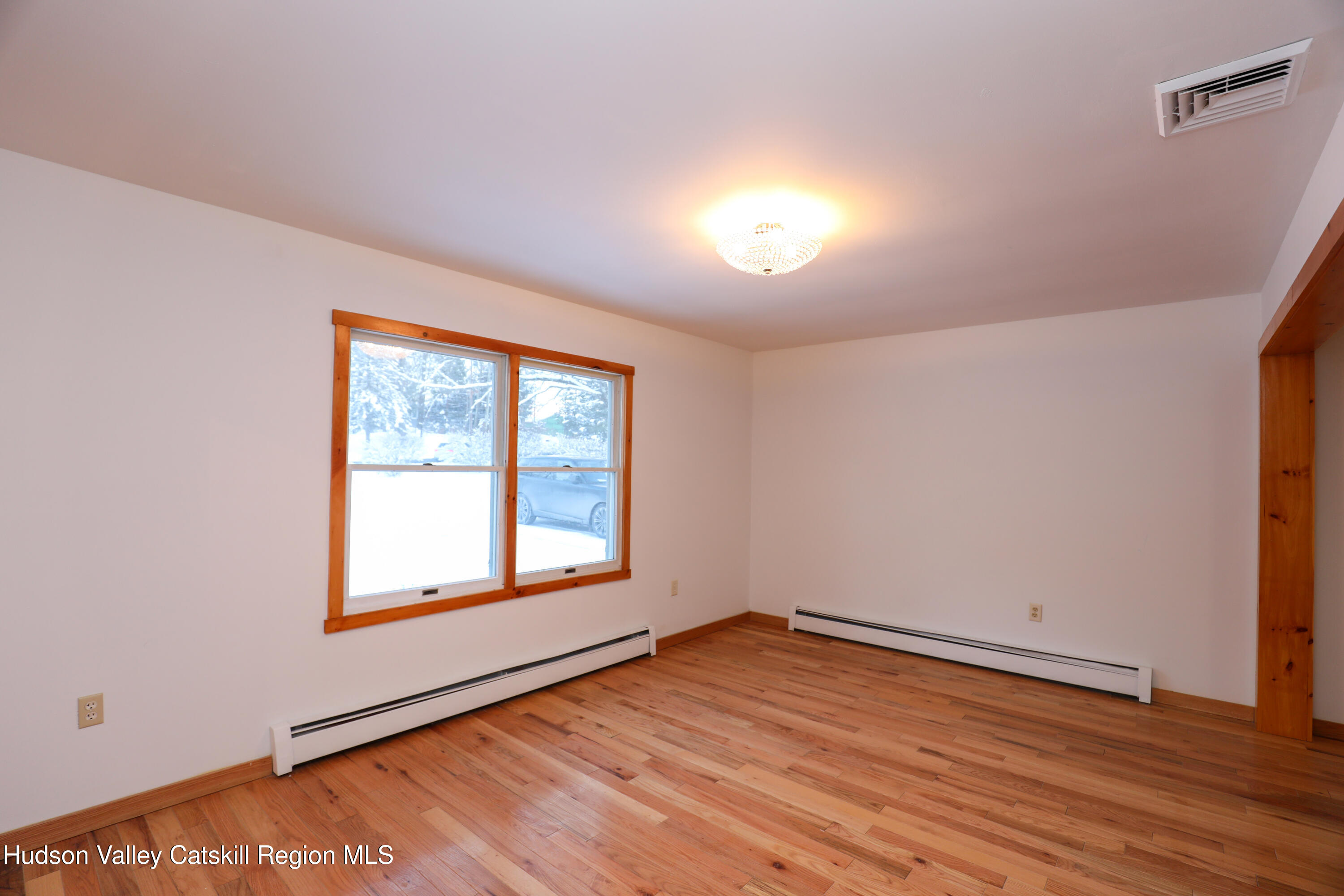 38 Roxanne Boulevard Highland, NY 12528 - Photo 4 of 42 an empty room with wooden floor and windows