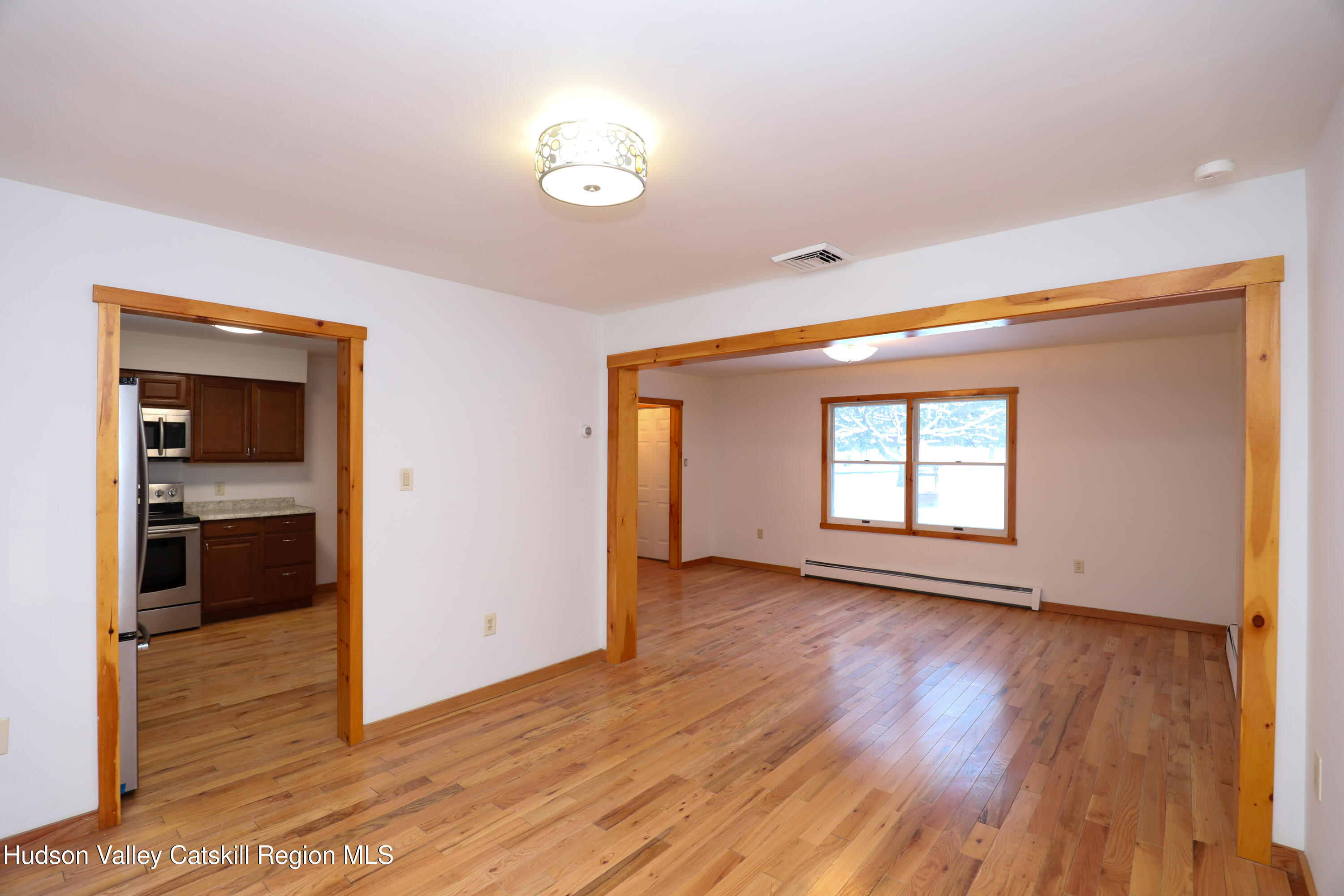38 Roxanne Boulevard Highland, NY 12528 - Photo 7 of 42 an empty room with wooden floor and windows