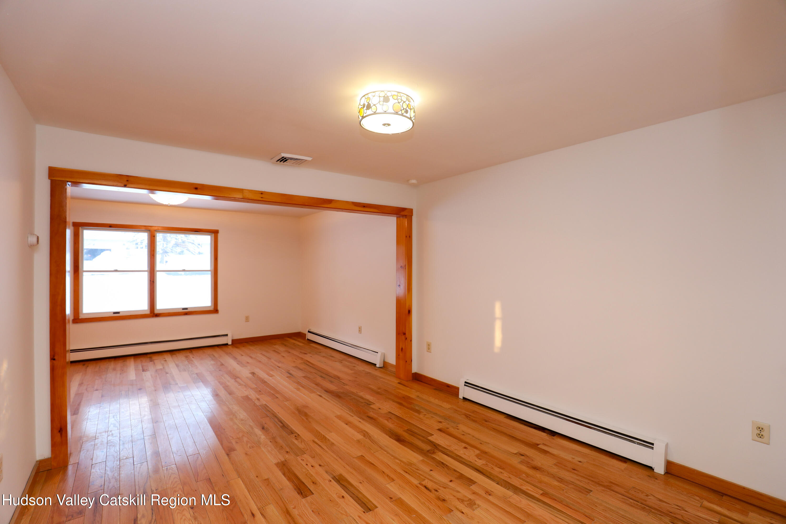38 Roxanne Boulevard Highland, NY 12528 - Photo 8 of 42 an empty room with wooden floor and windows