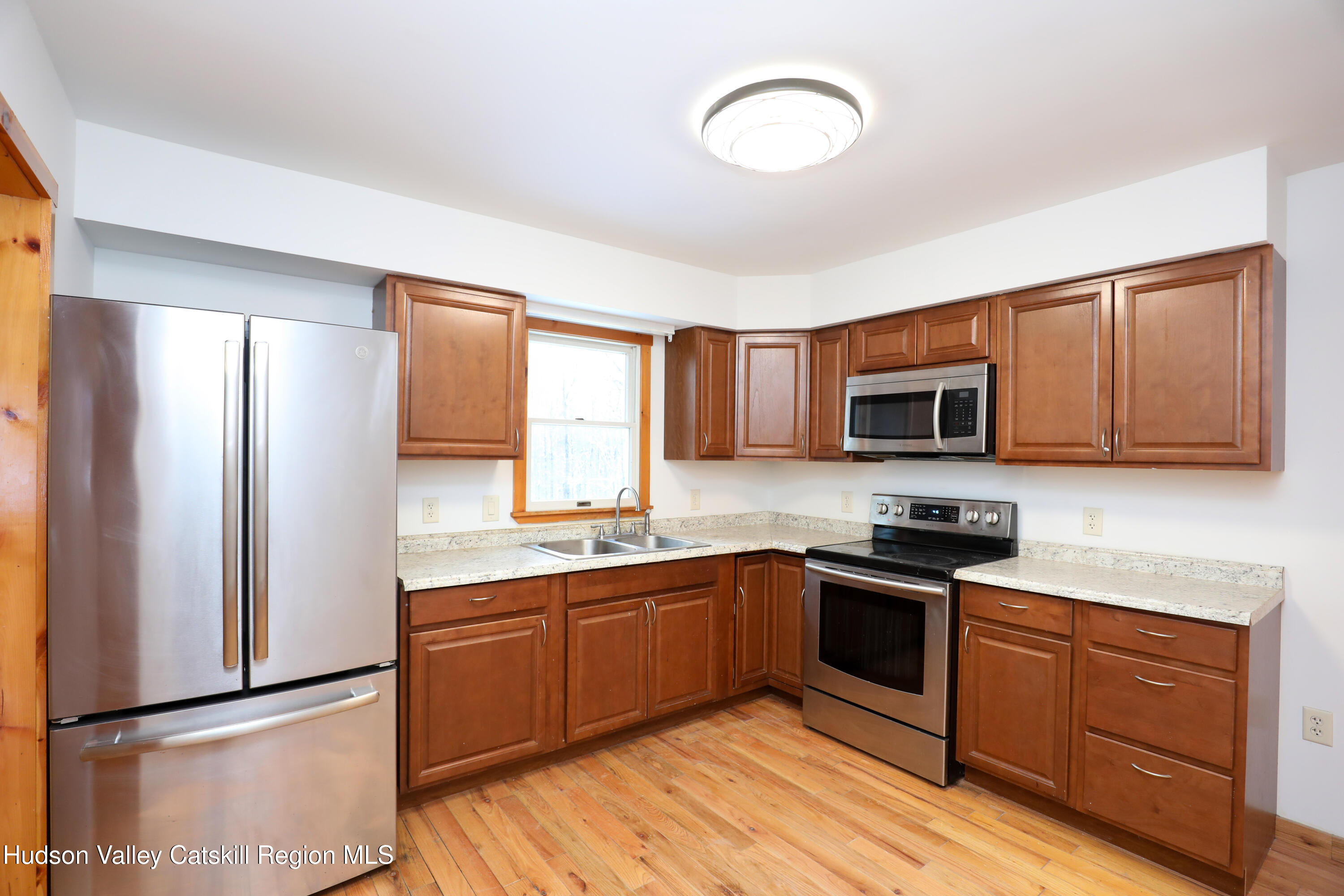 38 Roxanne Boulevard Highland, NY 12528 - Photo 10 of 42 a kitchen with stainless steel appliances granite countertop a stove a sink and a refrigerator