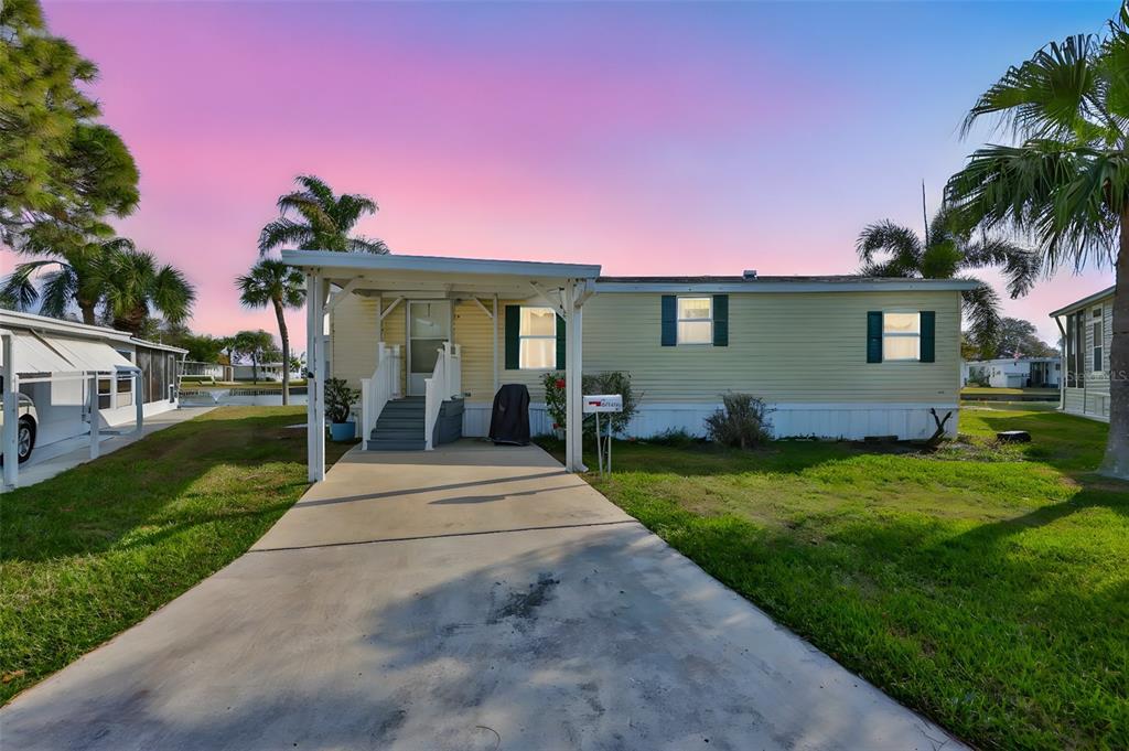 980 7th Street Northwest, Unit 16 Largo, FL 33770 - Photo 1 of 35 a front view of a house with a garden and yard