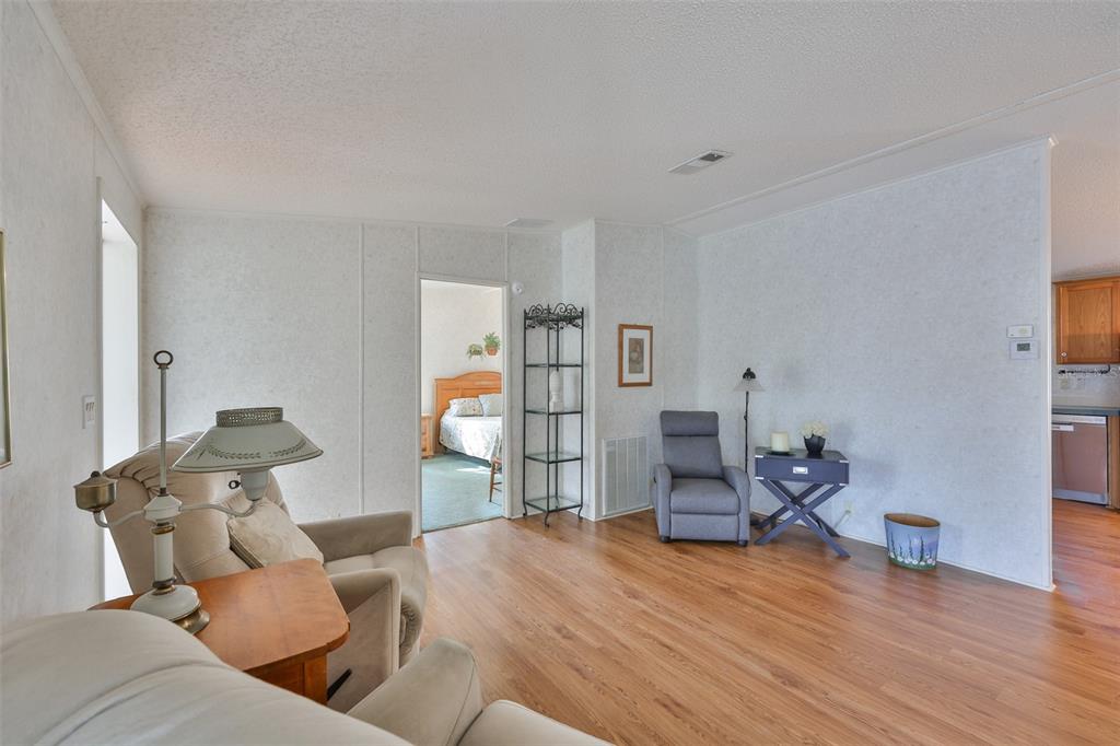 980 7th Street Northwest, Unit 16 Largo, FL 33770 - Photo 11 of 35 a living room with furniture and a wooden floor