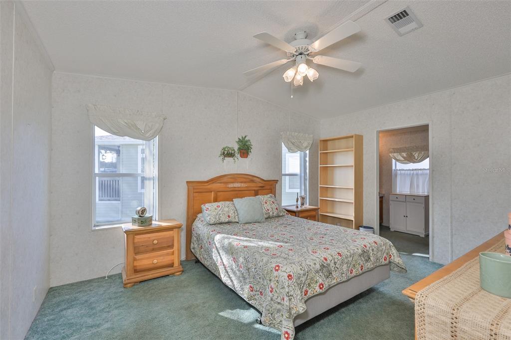 980 7th Street Northwest, Unit 16 Largo, FL 33770 - Photo 20 of 35 a bedroom with a bed and a chandelier