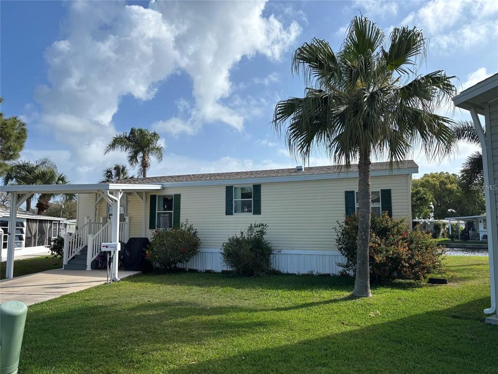 980 7th Street Northwest, Unit 16 Largo, FL 33770 - Photo 2 of 35 a view of a backyard of the house