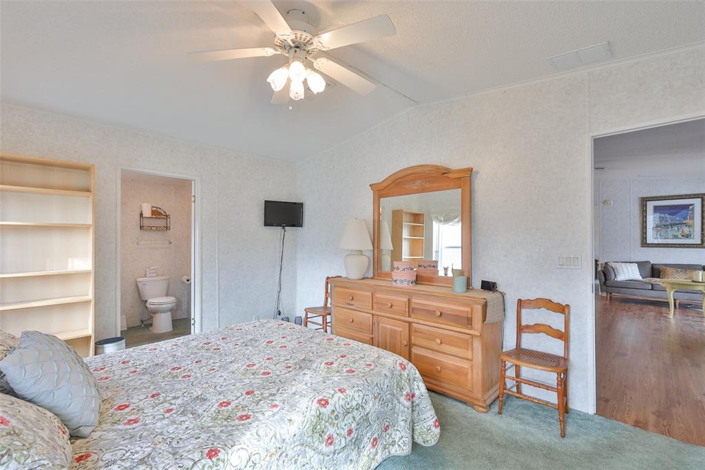 980 7th Street Northwest, Unit 16 Largo, FL 33770 - Photo 21 of 35 a bedroom with a bed and a dresser