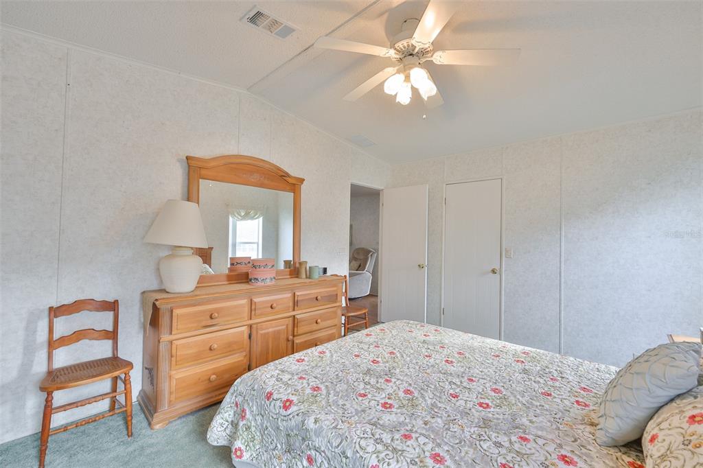 980 7th Street Northwest, Unit 16 Largo, FL 33770 - Photo 23 of 35 a bedroom with a bed and a chandelier