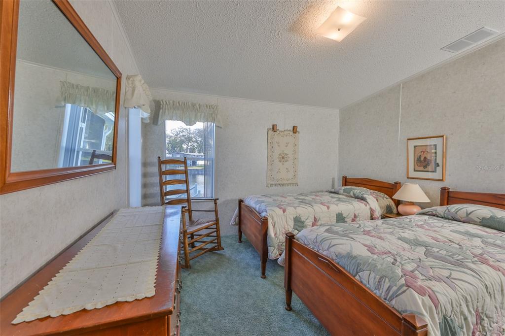 980 7th Street Northwest, Unit 16 Largo, FL 33770 - Photo 24 of 35 a bedroom with two beds and painted walls