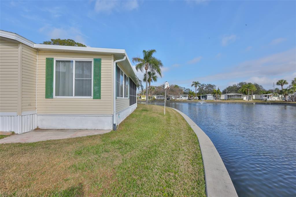 980 7th Street Northwest, Unit 16 Largo, FL 33770 - Photo 29 of 35 a swimming pool with outdoor seating and yard