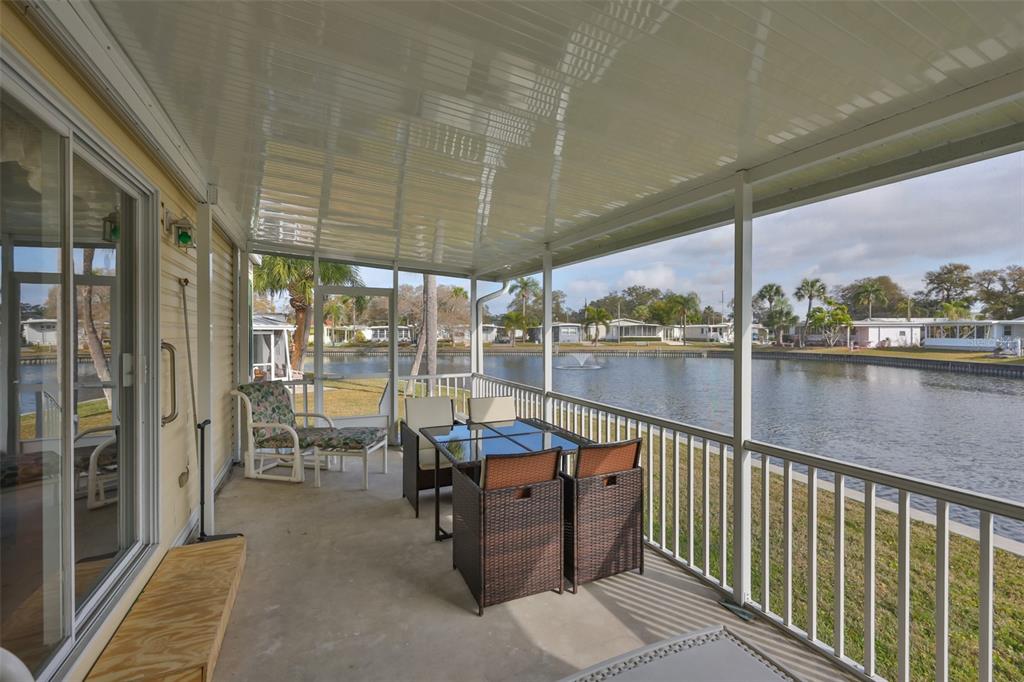 980 7th Street Northwest, Unit 16 Largo, FL 33770 - Photo 3 of 35 a balcony with chairs and with table