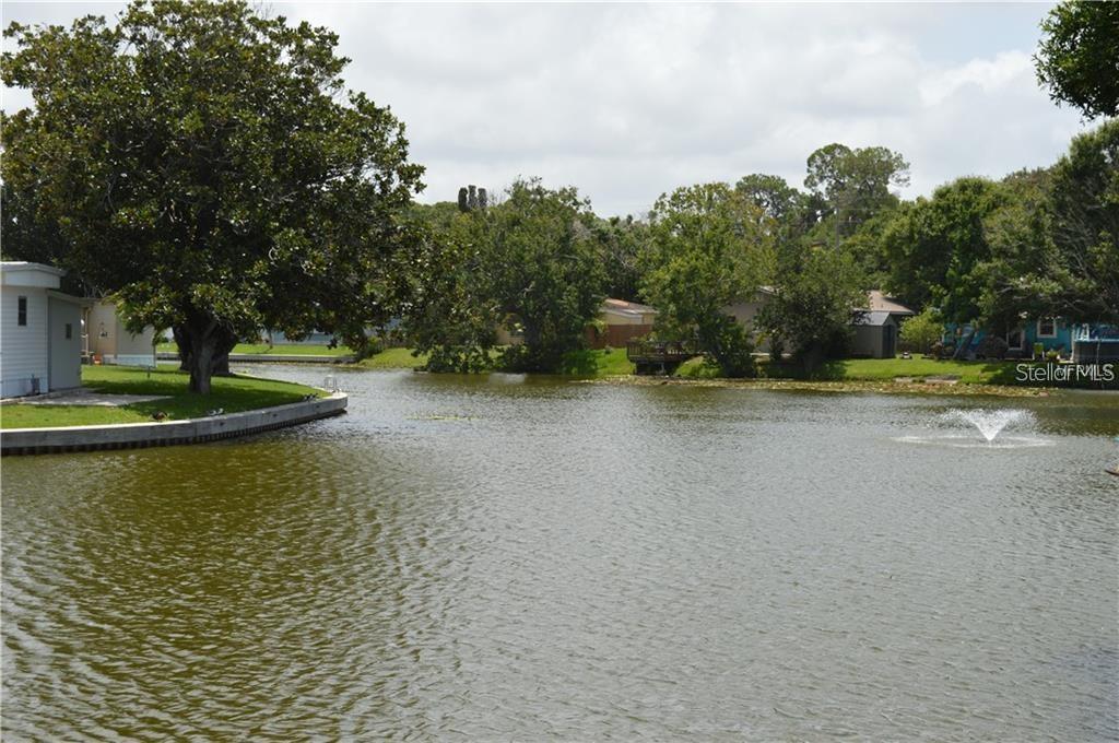 980 7th Street Northwest, Unit 16 Largo, FL 33770 - Photo 32 of 35 a view of a lake view with houses and trees in the background