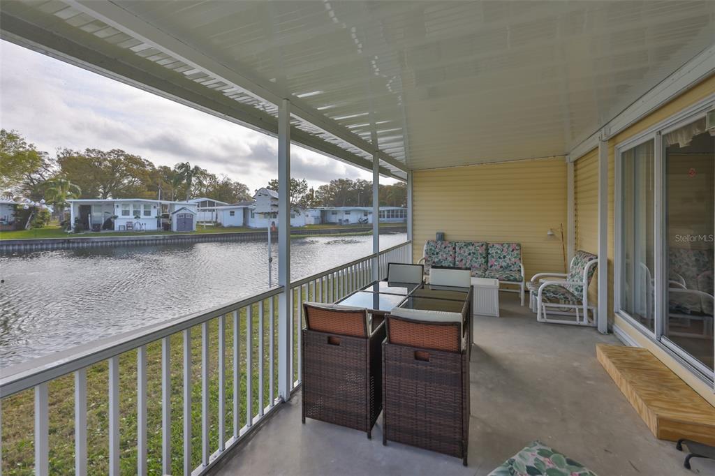 980 7th Street Northwest, Unit 16 Largo, FL 33770 - Photo 4 of 35 a view of a balcony with chairs