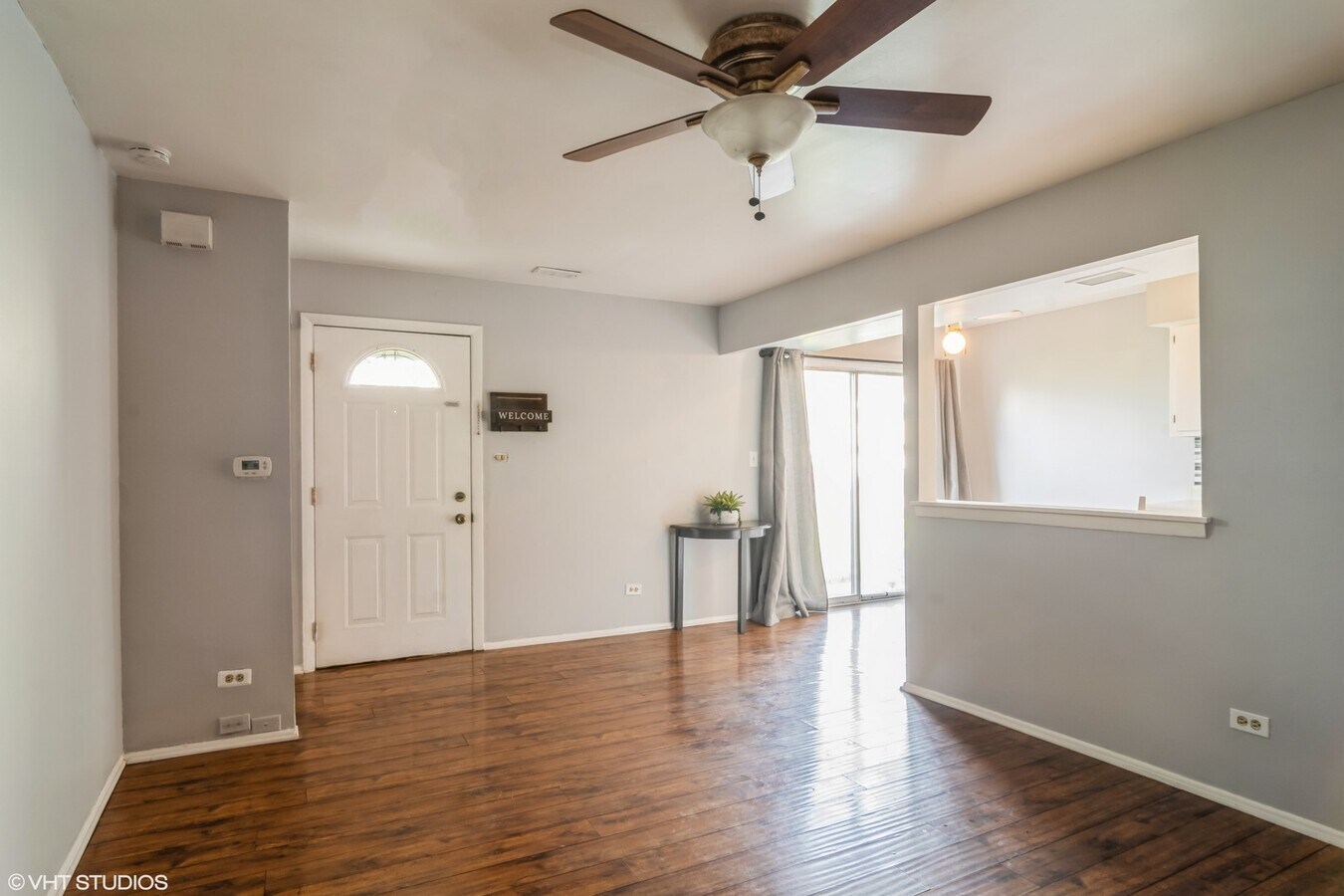 329 David Court, Unit B Bartlett, IL 60103 - Photo 5 of 11 wooden floor in an empty room with a window