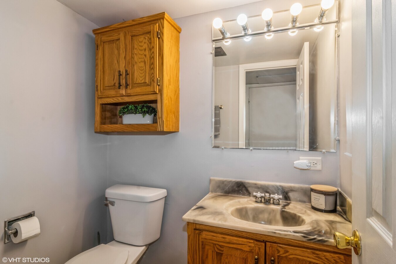 329 David Court, Unit B Bartlett, IL 60103 - Photo 8 of 11 a bathroom with a sink a toilet and mirror