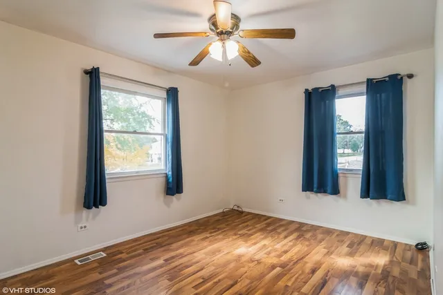 a view of a livingroom with a window and wooden floor