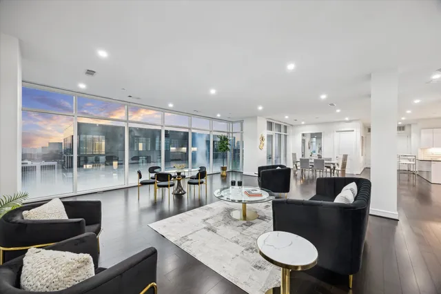 a dining room with furniture wooden floor and a floor to ceiling window
