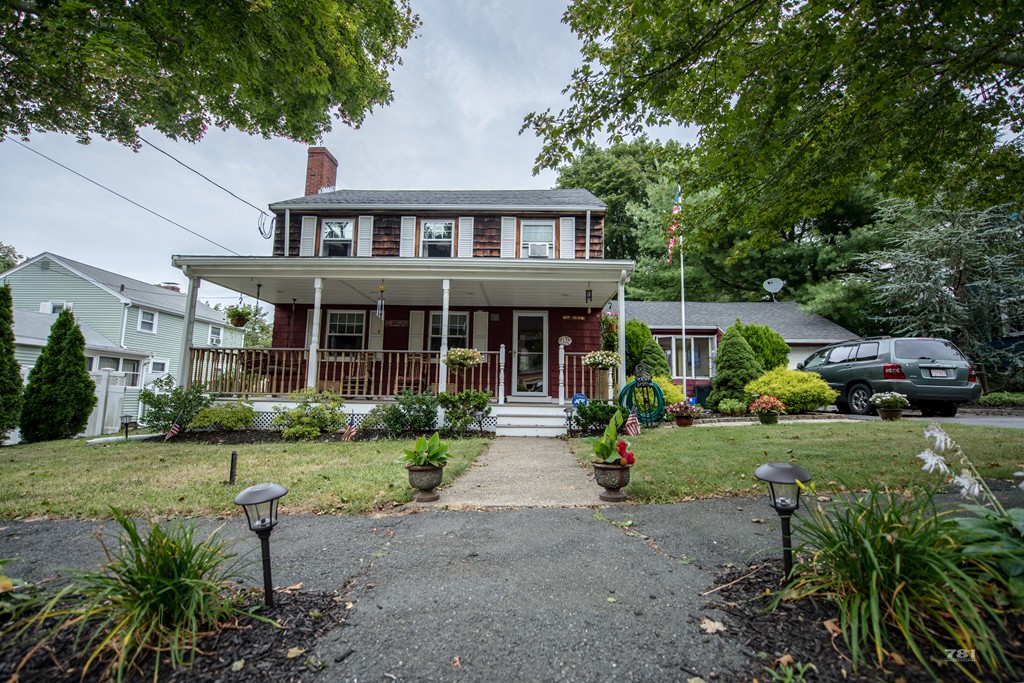 12 Surrey Road Salem, MA 01970 - Photo 1 of 15 a front view of a house with garden and porch