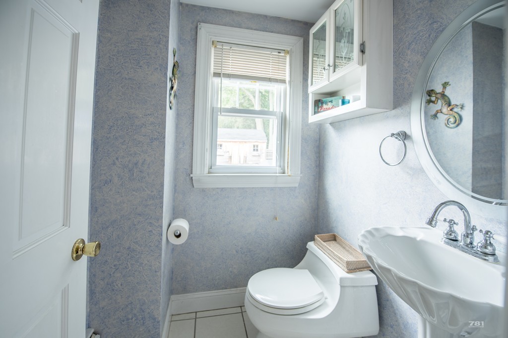 12 Surrey Road Salem, MA 01970 - Photo 11 of 15 a white toilet sitting next to a bathroom sink
