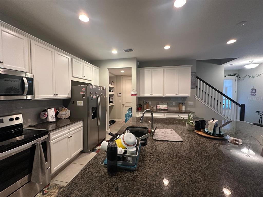 2101 Sunset Wind Loop Oldsmar, FL 34677 - Photo 4 of 13 a kitchen with sink refrigerator and cabinets