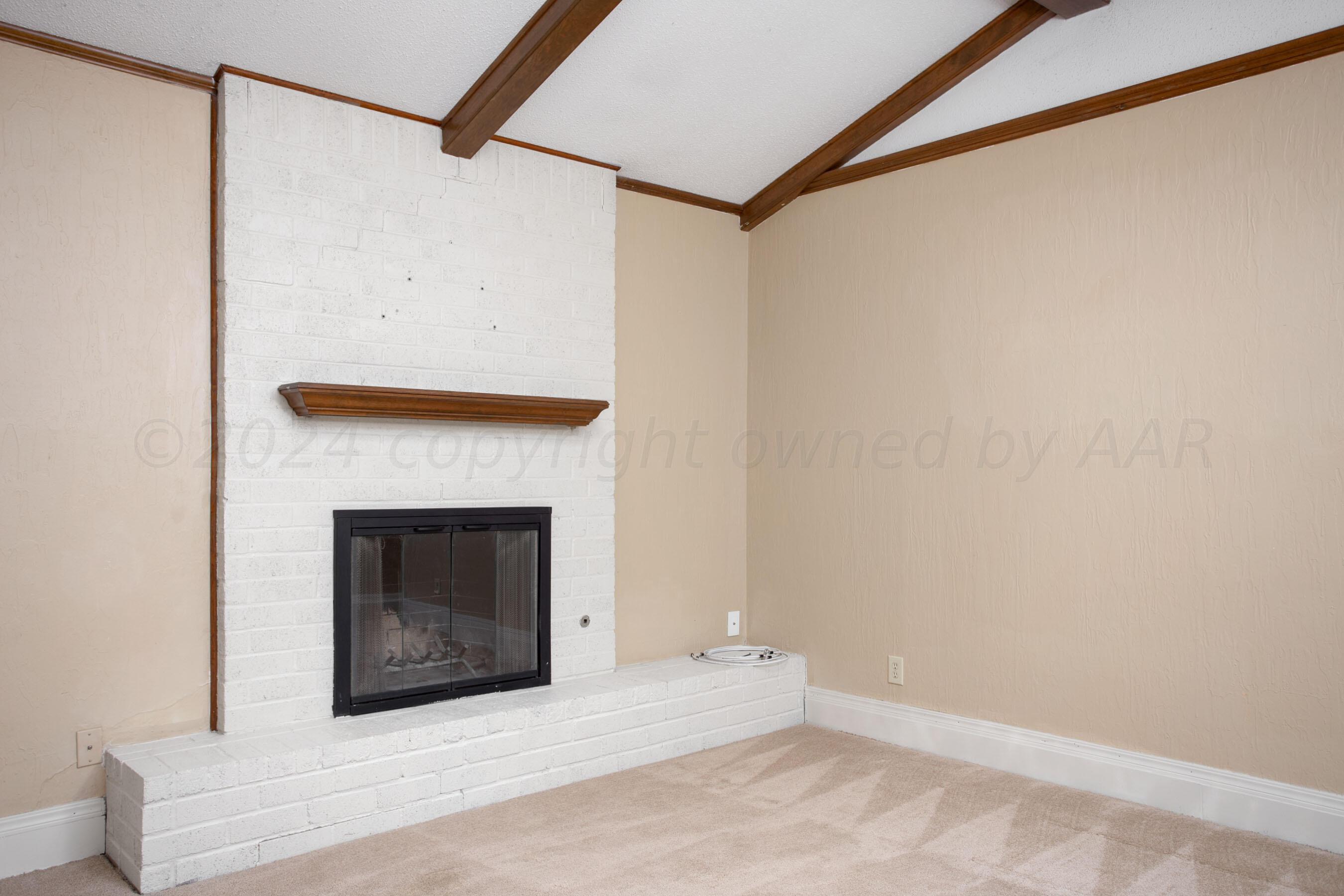 8328 Lamount Drive Amarillo, TX 79110 - Photo 11 of 24 a view of an empty room with a fireplace