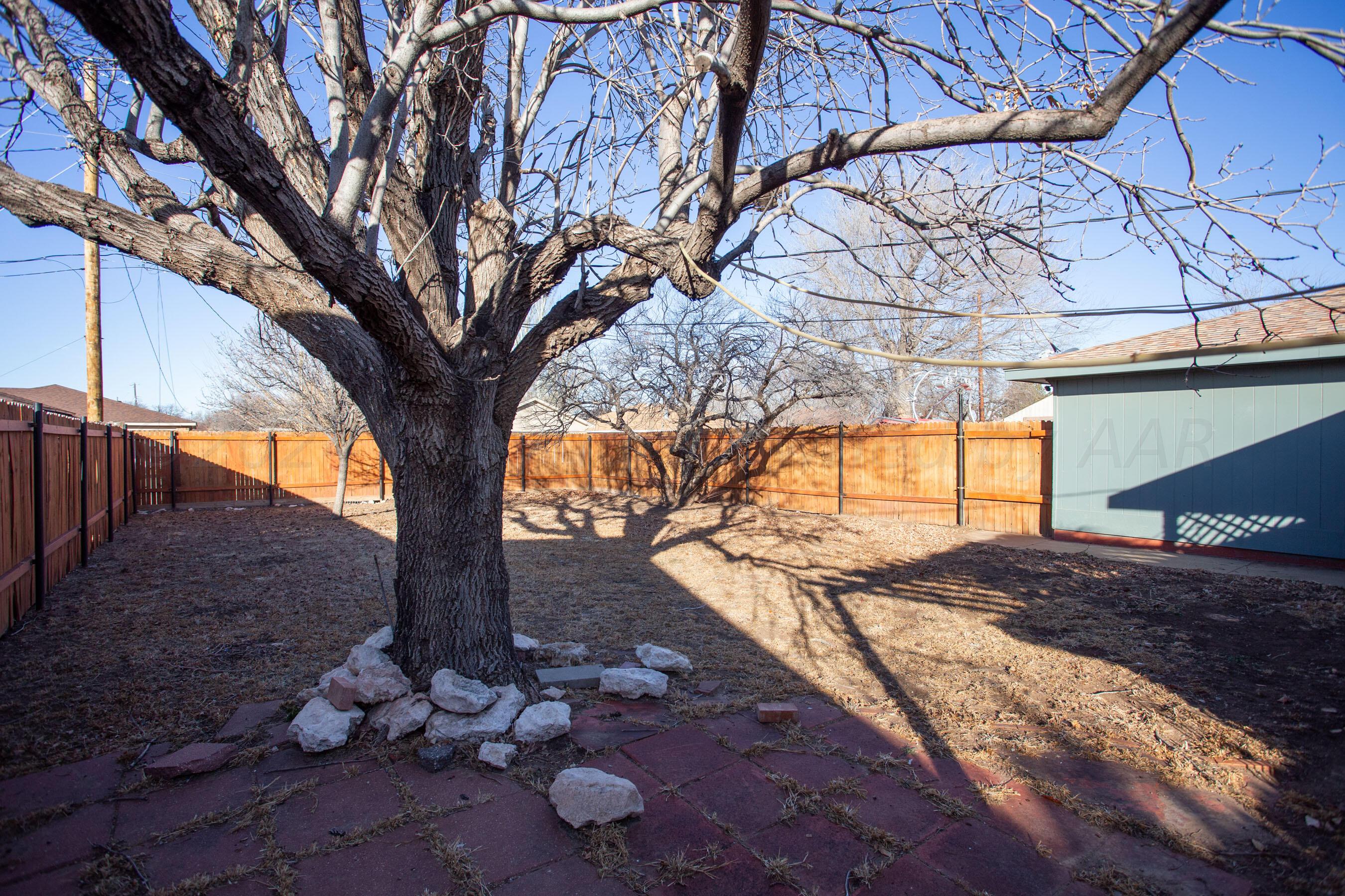 8328 Lamount Drive Amarillo, TX 79110 - Photo 21 of 24 a view of backyard with tree