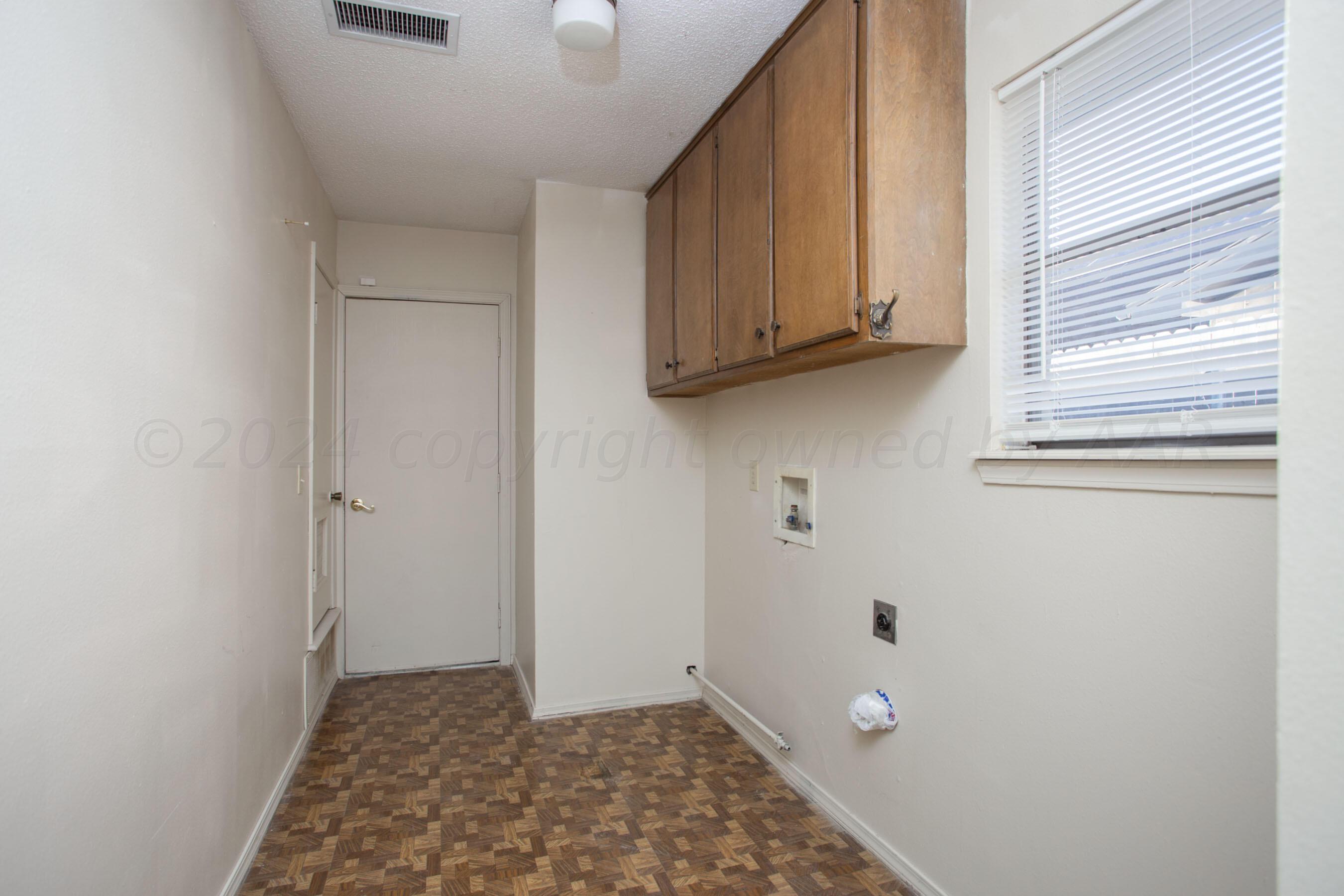 8328 Lamount Drive Amarillo, TX 79110 - Photo 24 of 24 a view of room with window and cabinets