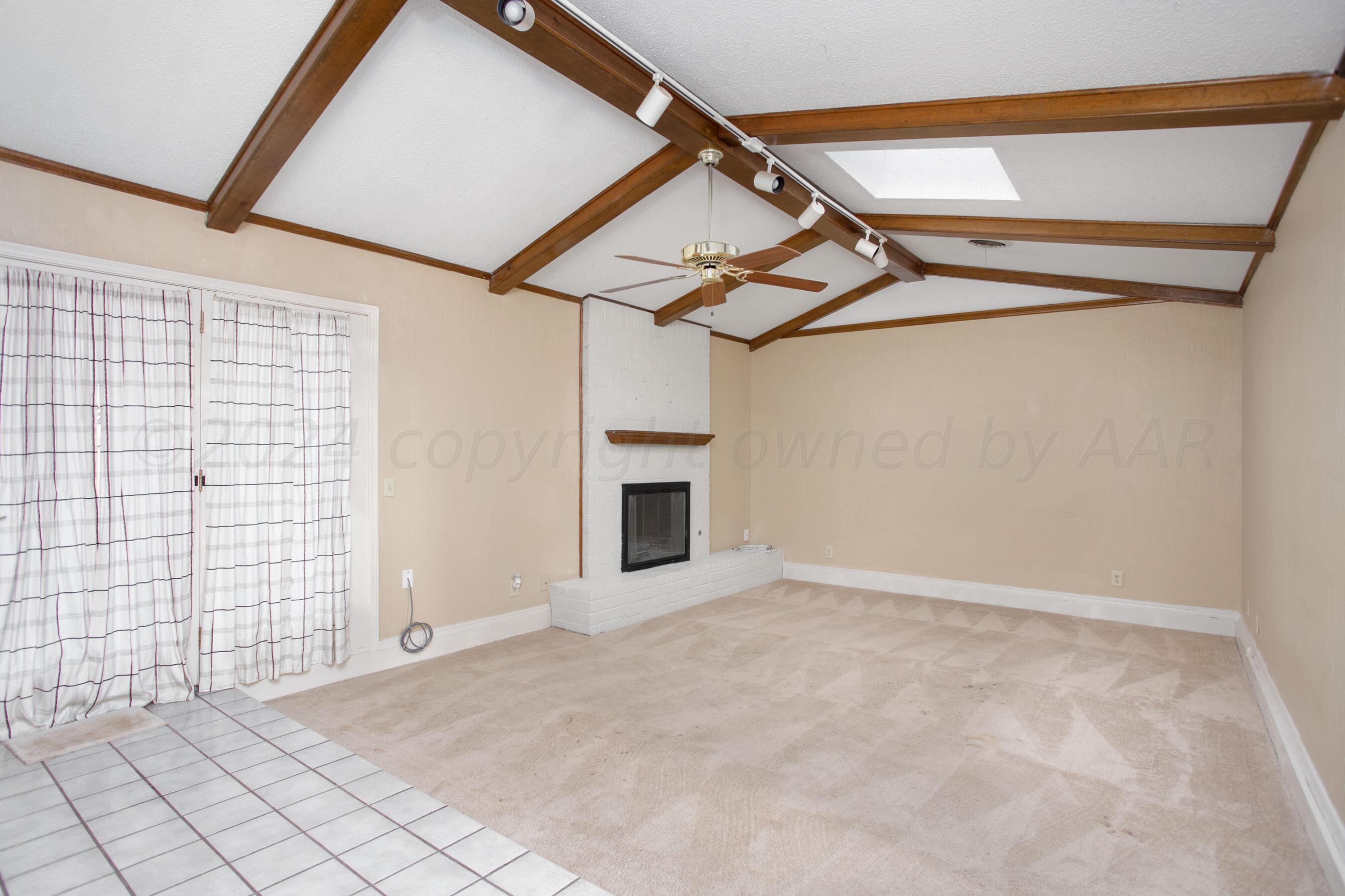 8328 Lamount Drive Amarillo, TX 79110 - Photo 10 of 24 a view of a livingroom with an empty space and a ceiling fan