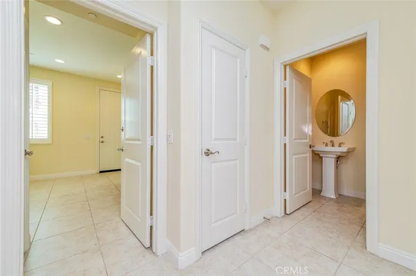 a view of a hallway with closet and a bathroom