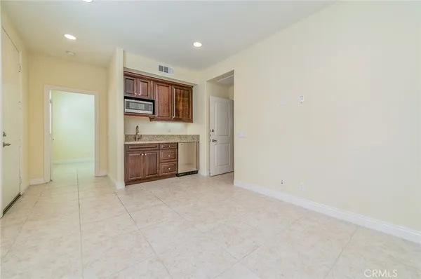 an empty room with a fireplace and cabinet