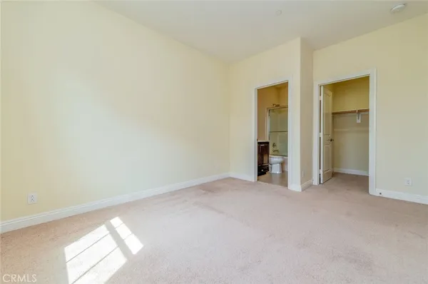 an empty room with closet and a window