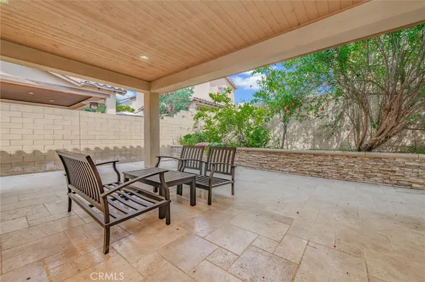 a view of a patio with table and chairs with wooden floor and fence