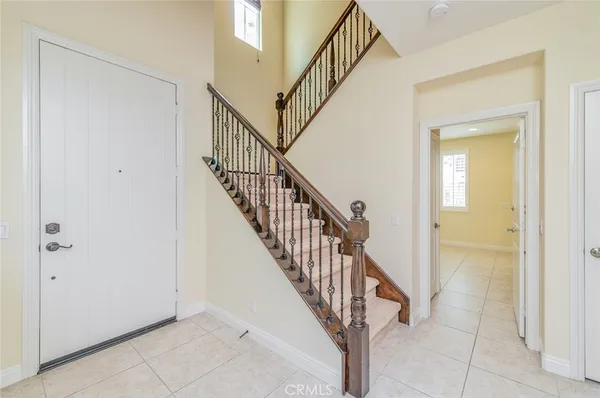 a view of staircase with railing and white walls